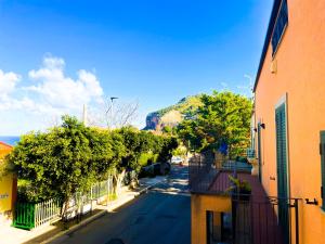 an empty street with trees on the side of a building at Domus Maris in Cefalù