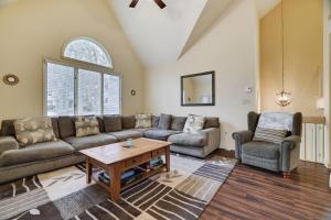 a living room with a couch and a table at Cozy Mountain & Lake Escape: Perfect for Groups in Lake Harmony