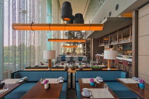 a dining room with tables and a large window at The Westin Santa Fe, Mexico City in Mexico City