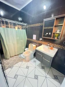 a bathroom with a toilet and a sink at Neo’s hotel in Santa Cruz de Barahona