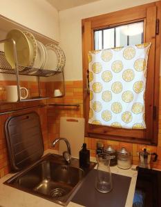a kitchen with a sink and a pillow on a window at The Smart Choice Apartments in Florence