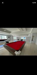 a pool table in a room with a red carpet at OCEANFRONT LUXURY IN JUAN DOLIO in Juan Dolio