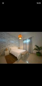 a bedroom with a large bed and a potted plant at OCEANFRONT LUXURY IN JUAN DOLIO in Juan Dolio