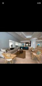 a large living room with couches and tables at OCEANFRONT LUXURY IN JUAN DOLIO in Juan Dolio