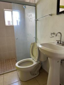 a bathroom with a toilet and a sink at Alojamiento privado con seguridad 1 in Tepic