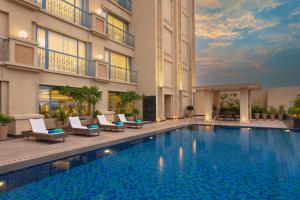 a swimming pool in front of a building at ITC Narmada, a Luxury Collection Hotel, Ahmedabad in Ahmedabad