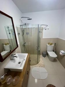a bathroom with a sink and a shower and a toilet at Playa del Hombre Deluxe Luxury Apartments in Playa del Hombre