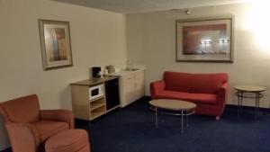 a living room with two chairs and a table at Days Inn by Wyndham Buena Park in Buena Park
