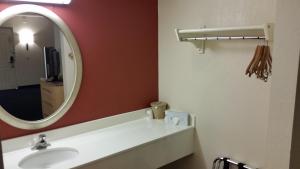 a bathroom with a sink and a mirror at Days Inn by Wyndham Buena Park in Buena Park
