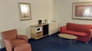 a living room with two chairs and a table at Days Inn by Wyndham Buena Park in Buena Park