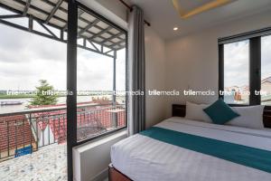 1 dormitorio con cama y ventana grande en Rockmouse Centre River Villa Hoi An, en Hoi An