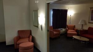 a hotel room with chairs and a waiting room at Days Inn by Wyndham Buena Park in Buena Park