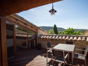 a patio with a table and chairs on a building at Domaine de Monteils in Carnas