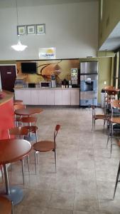 a cafeteria with tables and chairs and a kitchen at Days Inn by Wyndham Buena Park in Buena Park