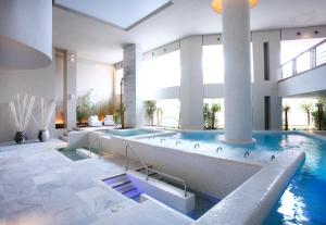 a large swimming pool in a building with a swimming pool at Royal Hideaway Sancti Petri in Chiclana de la Frontera