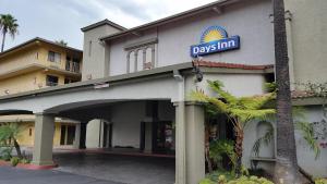 a day inn sign on the side of a building at Days Inn by Wyndham Buena Park in Buena Park