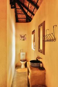 a bathroom with a sink and a toilet in a room at Hyenas Call in Marloth Park +34 photos