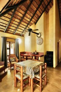 a dining room with a table and chairs at Hyenas Call in Marloth Park