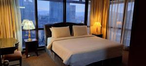 a bedroom with a bed and a large window at Bunga Suite at Times Square in Kuala Lumpur