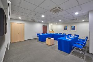 a room with blue tables and chairs in it at City Express by Marriott Tepotzotlán in Tepotzotlán