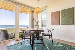 a dining room with a table and chairs and the ocean at Manhattan Beach as your Backyard The Strand in Manhattan Beach