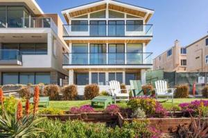 a building with chairs and flowers in front of it at Manhattan Beach as your Backyard The Strand in Manhattan Beach