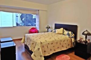 a bedroom with a large bed and a window at Excellent apartment, access to pool, grills, ballroom in Lima +34 photos