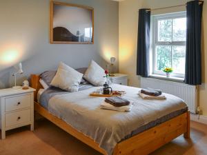 a bedroom with a bed with two towels on it at The Waiting Room in Falstone