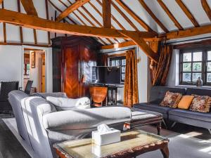 a living room with couches and a table at Barn Suite in Beaconsfield