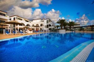 a large swimming pool in front of a building at Waves of Tranquility Residence in San Miguel de Abona