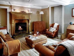 a living room with couches and a fire place at Bradley Hall in Stanton in Peak