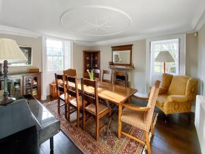 a living room with a wooden table and chairs at Bradley Hall in Stanton in Peak