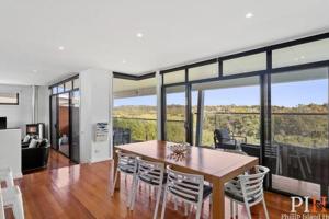 a dining room with a table and chairs at Villa Isola Golf Course Views in Cowes