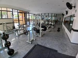 a gym with several treadmills and weights in a room at Saint Martin By Escala Imóveis in Fortaleza