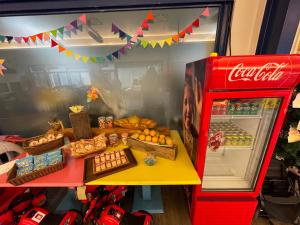 a table with a cocacola machine and some food at Follow Me designed B&B in Dongshan