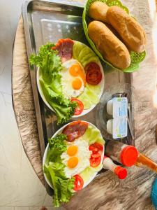 twee sandwiches met eieren en sla op een dienblad bij Lộc Vừng Homestay in Phan Thiet