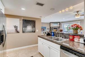 a kitchen with a sink and a refrigerator at AWESOME 3BR 1 Block To Ocean Fast WIFI C1 in Newport Beach