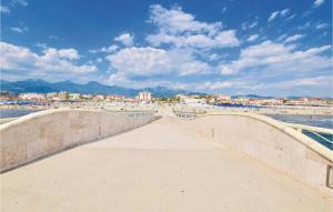 a bridge over a beach with a city in the background at Villetta Della Pace in Lido di Camaiore
