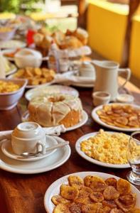 a table topped with plates of food and pastries at Pousada Recanto das Estrelas in Morro de São Paulo +35 photos