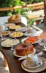 a table with many plates of food on it at Pousada Recanto das Estrelas in Morro de São Paulo