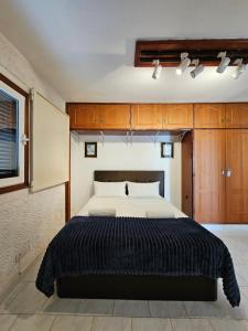 a bedroom with a large bed and wooden cabinets at TABAIBA REFUGIO DEL MAR in Santa Cruz de Tenerife