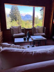 a room with two chairs and a table and a window at Casa Buena Vista in San Carlos de Bariloche
