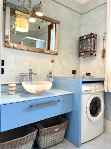a bathroom with a sink and a washing machine at Borgo al Mare in Lido di Jesolo
