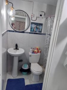 a small bathroom with a toilet and a sink at Chic Vybz Deluxe in Four Mile