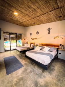 a bedroom with two beds in a room at Jungla EcoLuxury Resort in Villeta