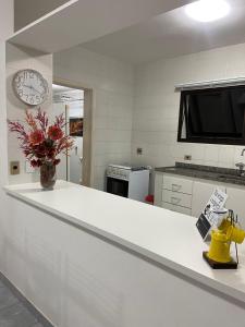 cocina con encimera blanca y reloj en MARINA MAR, en Caraguatatuba