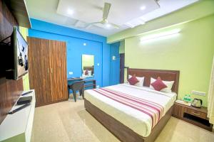 a bedroom with a bed and a desk and a television at RedKEY Inn Bangalore Airport - Pick up & Drop Available 24x7 in Yelahanka