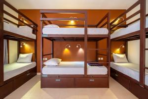 a bunk bed room with three bunk beds in it at Gelatik Bed And Breakfast in Seminyak