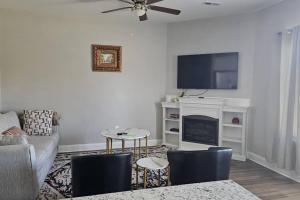 a living room with a couch and a tv at Spacious 3-Bedroom Modern Home Near CLT Motor Speedway in Concord