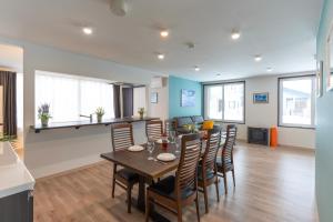 a dining room and living room with a table and chairs at FuranoSky - White in Furano